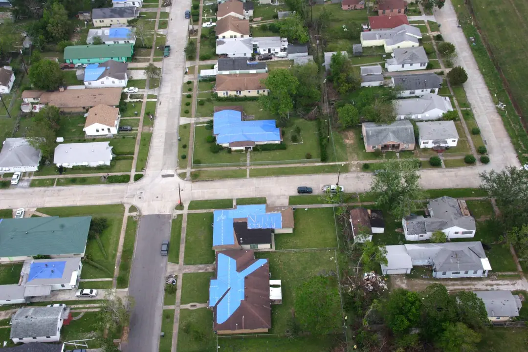 Aerial view of Sabine Pass, Texas after Hurricane Rita, with blue tarps covering damaged roofs